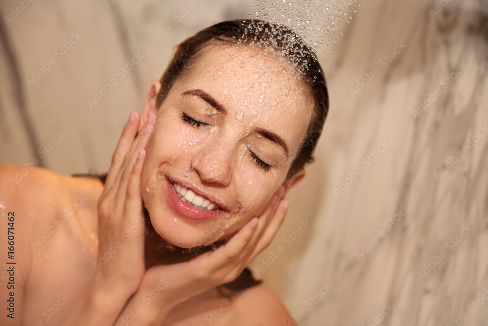 Naklejka premium Young beautiful woman taking shower in bathroom
