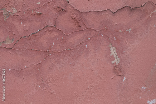 Pink wall texture with peeling paint. Grunge background for your design.