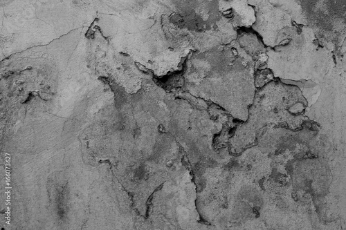 Wall texture with peeling paint. Black and white grunge background.