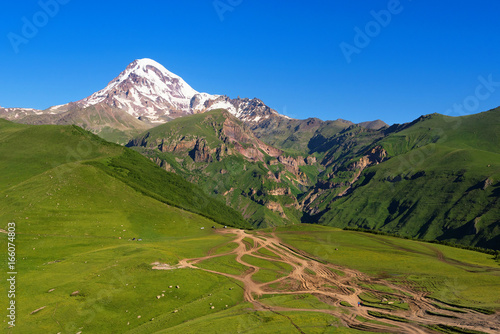 Mount Kazbek (5033 meters) view from Stepantsminda town in Georgia in good weather for climbing. It is a dormant stratovolcano and one of the major mountains of the Caucasus.
