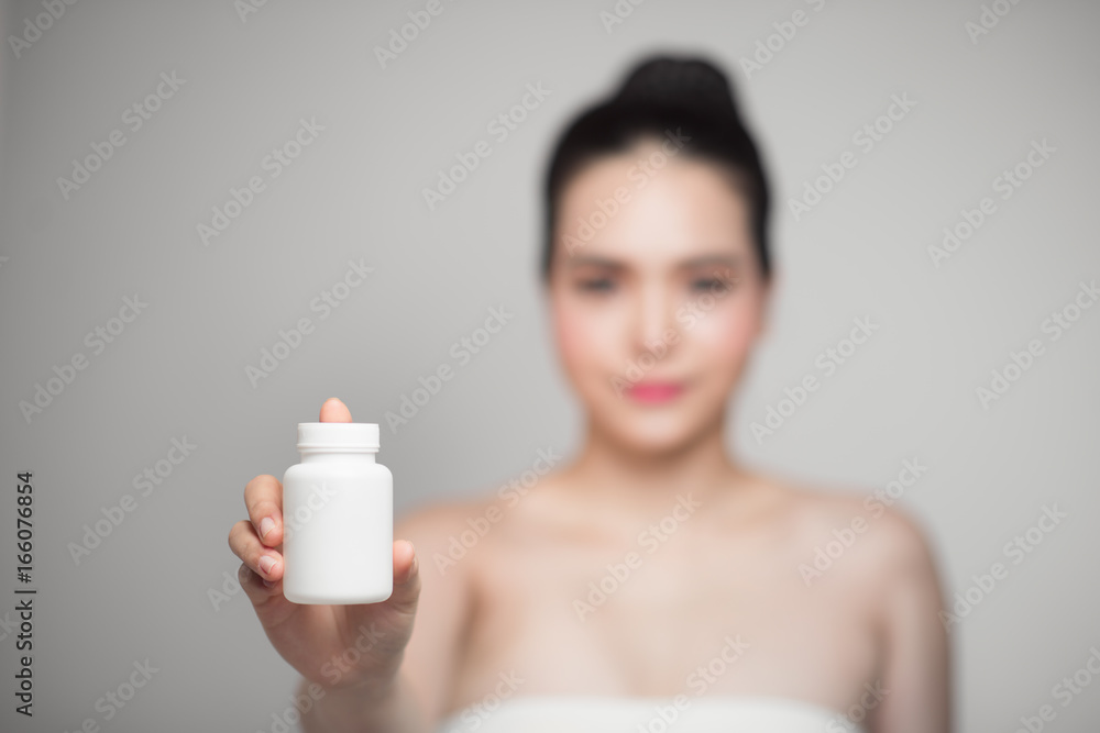 Healthy happy asian woman with pills bottle in hand. Healthy happy asian woman with pills bottle in hand.