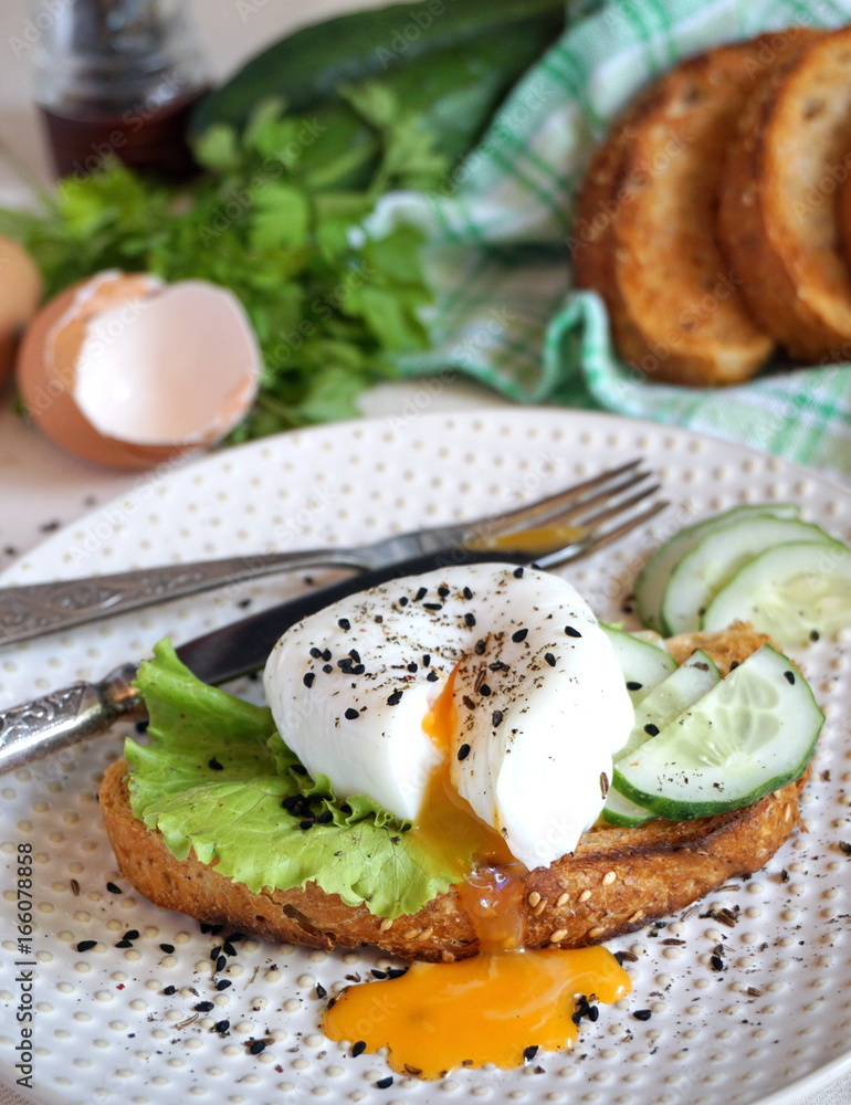Egg poached on toast with lettuce and cucumber Egg poached on toast with lettuce and cucumber