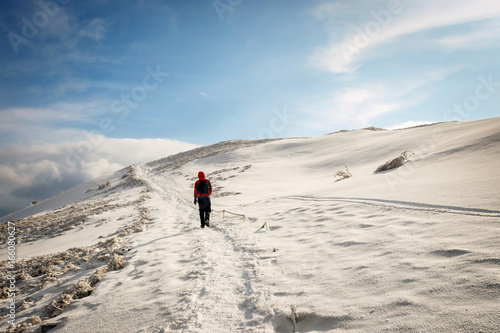 Mountain hiker in bad weather during winter