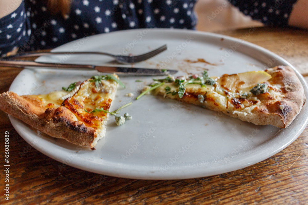 Four cheese pizza on a white plate with rucola lettuce Four cheese pizza on a white plate with rucola lettuce