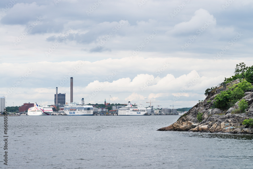 View over Frihamnen port in Stockholm, Sweden, with several big ships waiting as seen from water