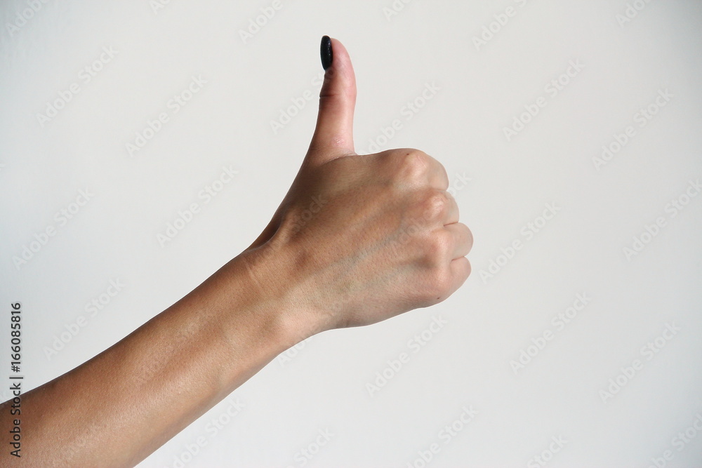 Young woman's hand shows thumbs up. Gesture.