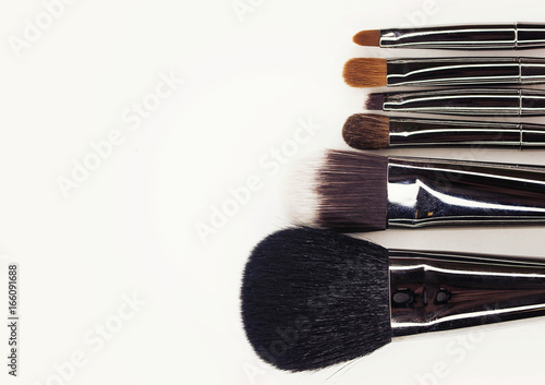 Make-up brushes with silver handle.