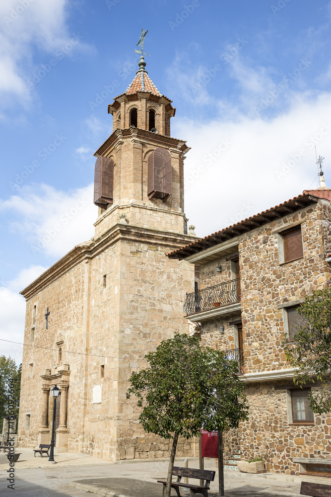 a street and Nuestra Señora de la Asunción parish church in Caminreal, province of Teruel, Spain