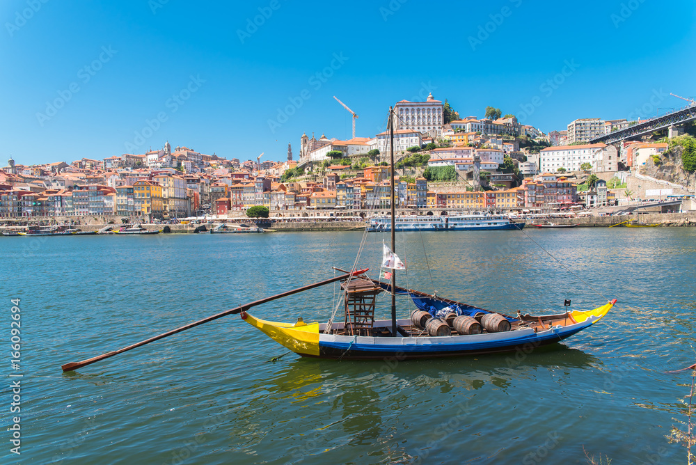 Porto in portugal, traditional boat for porto wine, panorama of the Douro and city
Porto in portugal, traditional boat for porto wine, panorama of the Douro and city