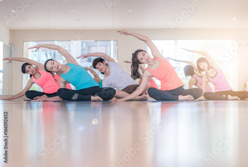 Fitness Asian woman at stretching training at gym fitness center. Young slim girl makes aerobics exercise.Yoga Practice Exercise Class Concept