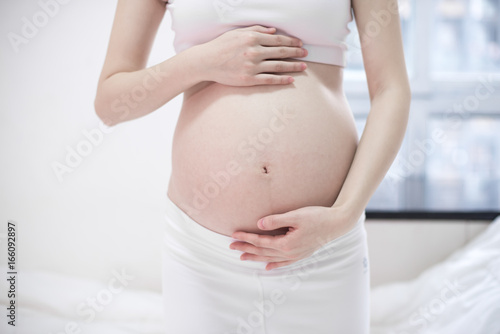 Pregnant woman relaxing at home on the couch