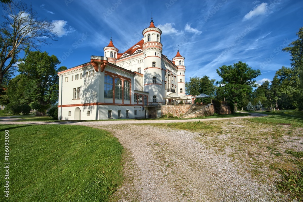 Neo-Gothic style palace surrounded by an English landscape garden in Wojanow, Poland