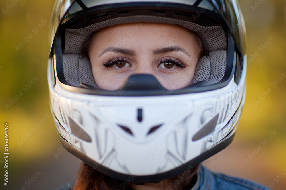 Close-up photo of girl in helmet with forest background Close-up photo of girl in helmet with forest background