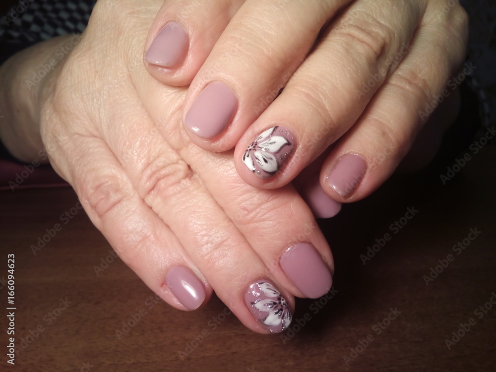 The manicurist excellently made her work a beautiful manicure with a polish gel on her hands and the client is happy The manicurist excellently made her work a beautiful manicure with a polish gel on her hands and the client is happy