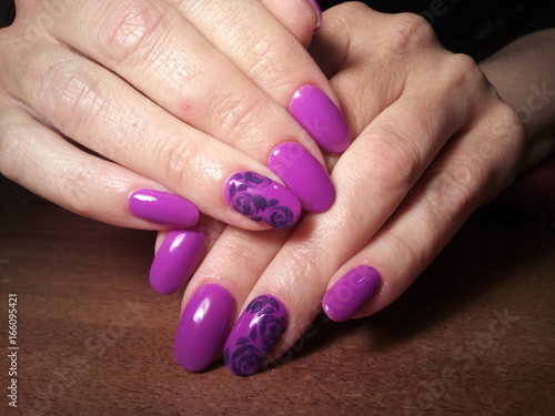 The manicurist excellently made her work a beautiful manicure with a polish gel on her hands and the client is happy