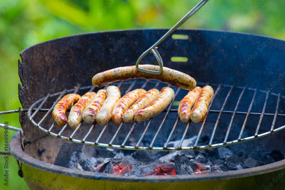 Barbecue sausages are grilled on a barbecue