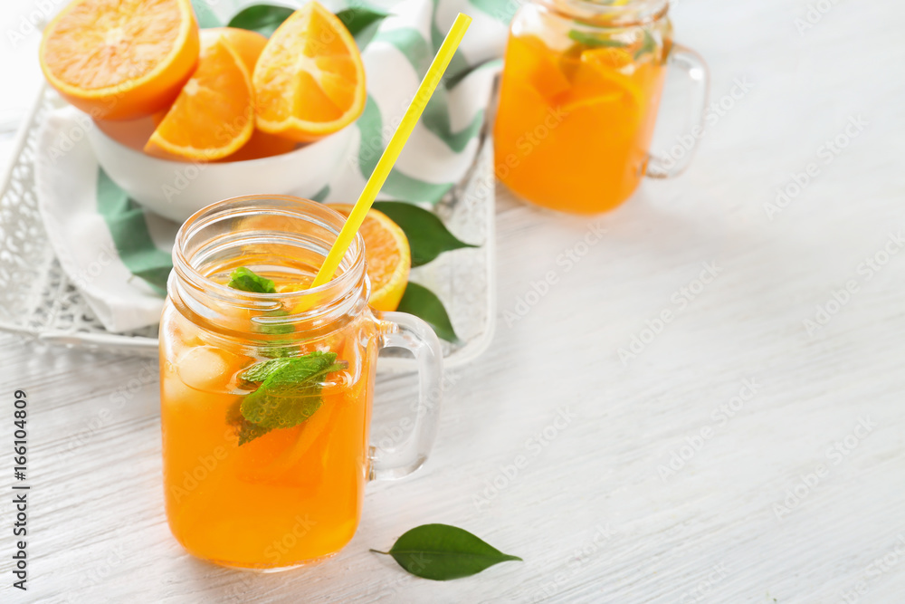 Mason jar of fresh orange lemonade on wooden background Mason jar of fresh orange lemonade on wooden background