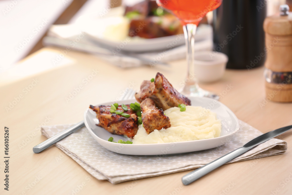 Plate with delicious pork ribs and mashed potatoes on table Plate with delicious pork ribs and mashed potatoes on table