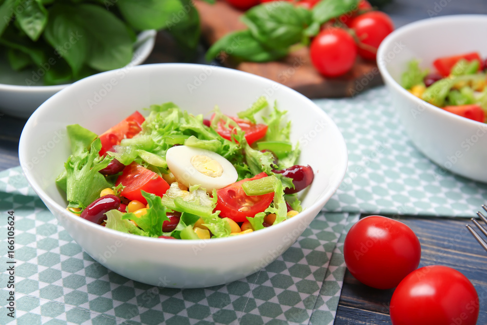 Bowl of fresh vegetable salad on wooden table Bowl of fresh vegetable salad on wooden table