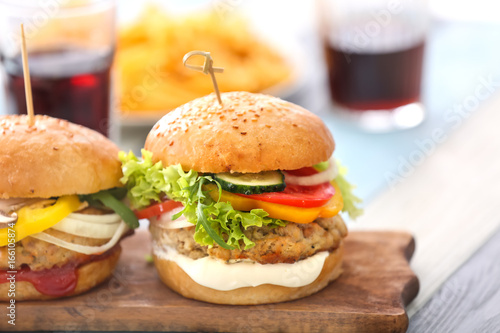 Wallpaper Mural Two turkey burgers on wooden board, close up Torontodigital.ca