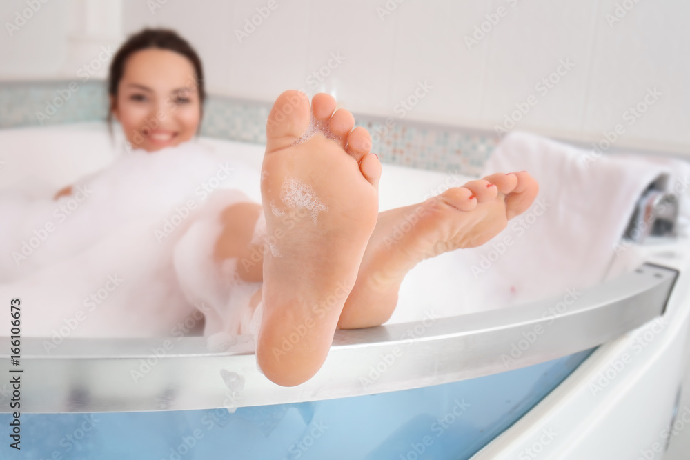 Beautiful woman relaxing in bathtub Stock Photo