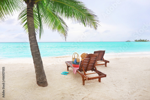 Fototapeta Naklejka Na Ścianę i Meble -  Sun loungers with beach accessories at tropical resort