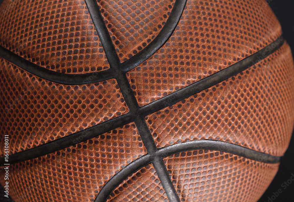 Fototapeta premium Old basketball ball on black background closeup