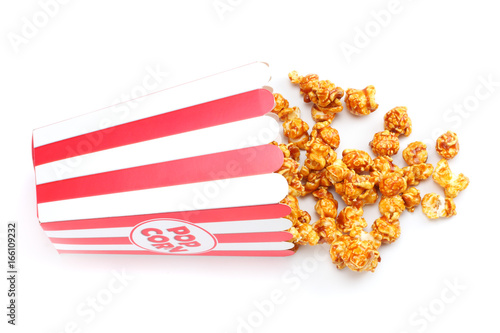 Popcorn in striped bucket isolated on white background