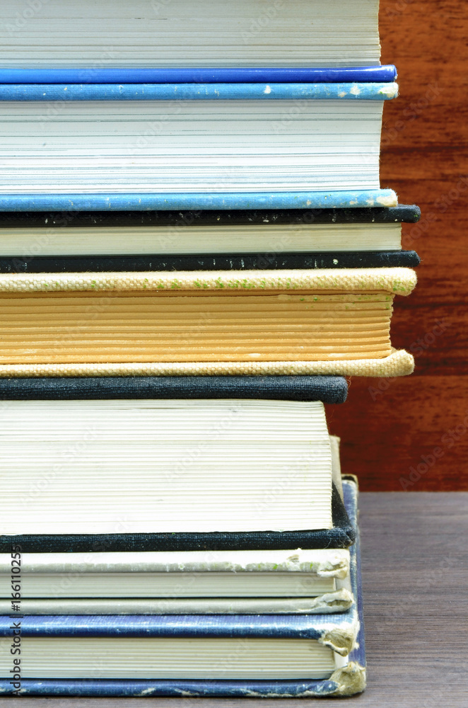many books stacked close up photo with wood background many books stacked close up photo with wood background