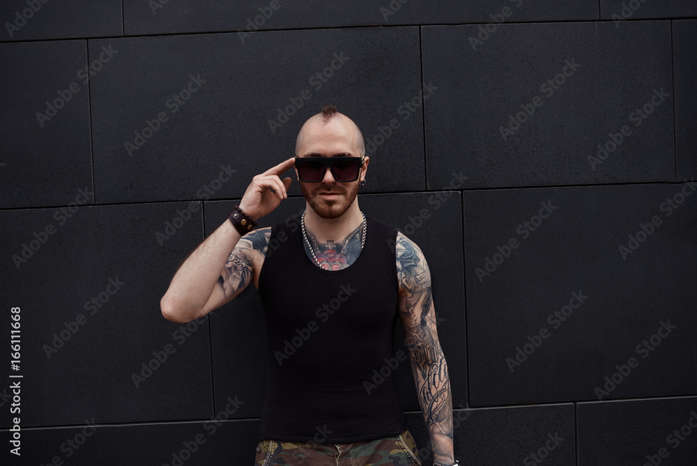 Isolated Picture Of Charismatic Trendy Looking Young Tattooed Hooligan With Thick Beard And Mohawk Adjusting His Stylish Sunglasses People Urban Lifestyle Fashion And Street Style Concept Stock Photo Adobe Stock