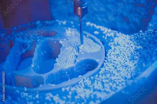 Dental milling machine carving out shape of human teeth