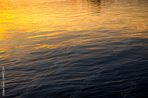 Surface of a water in lake during the sunset, Light is on the surface of water background