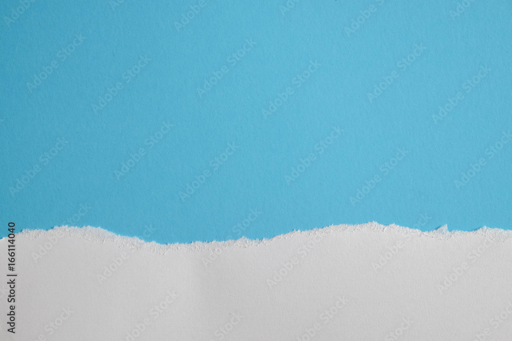 Obraz premium white torn paper with blue background, ready for design