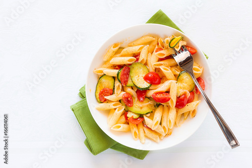 Italian penne pasta with zucchini and cherry tomatoes