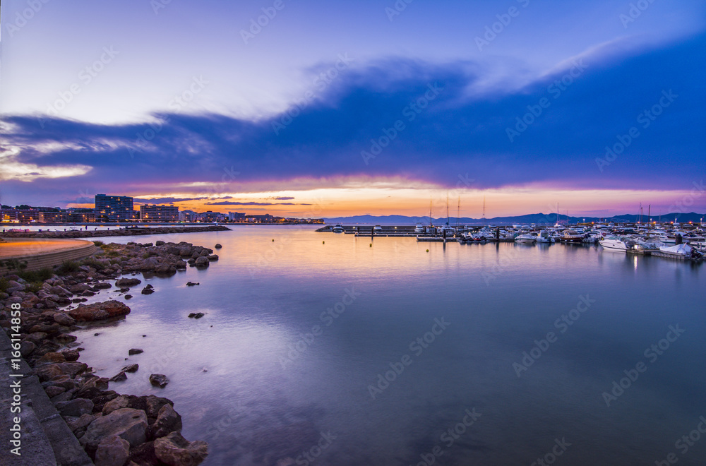 Sunset in quiet mediterranean port of l'Escala, Costa Brava.