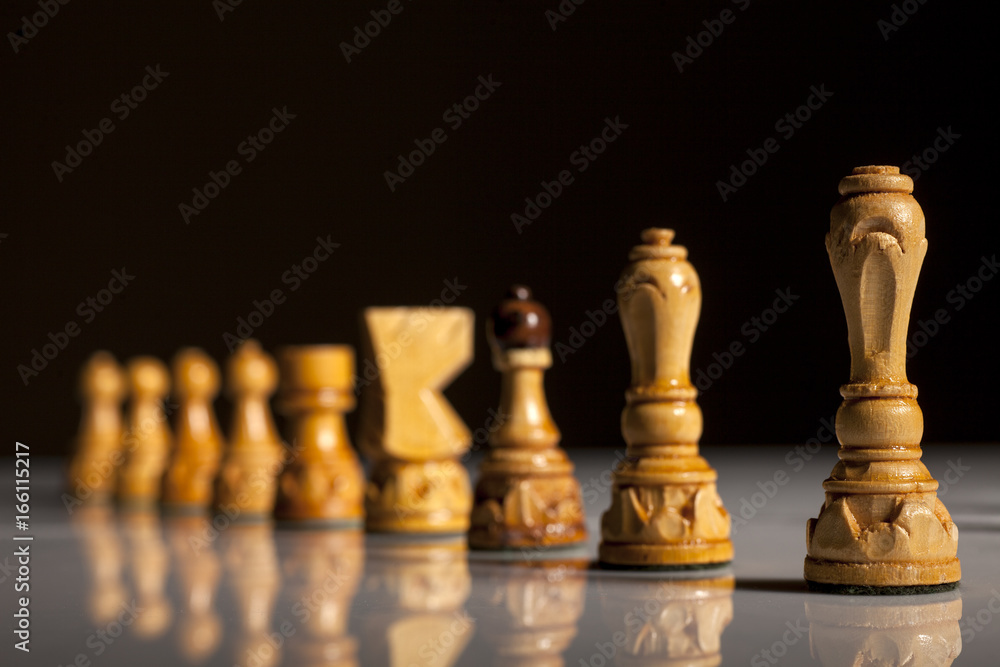 White chess pieces on a black background White chess pieces on a black background