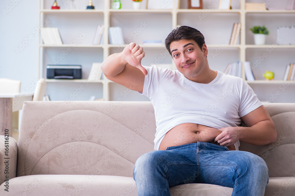 Man suffering from extra weight in diet concept Man suffering from extra weight in diet concept