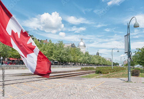 Montreal Old Port scenery during summer time  with Canadian flag waving photo