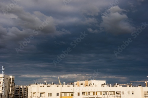 a view on residential buildings wit the stormy clouds