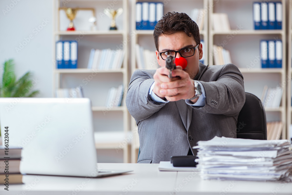 Clown businessman working in the office angry frustrated with a Clown businessman working in the office angry frustrated with a
