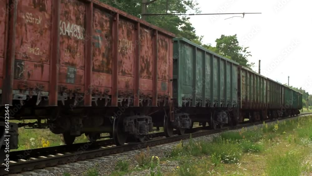 Railroad train move Freight train with cargo containers passing by