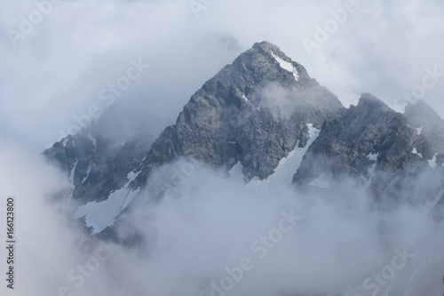 high mount peak in a dense clouds © Yuriy Kulik