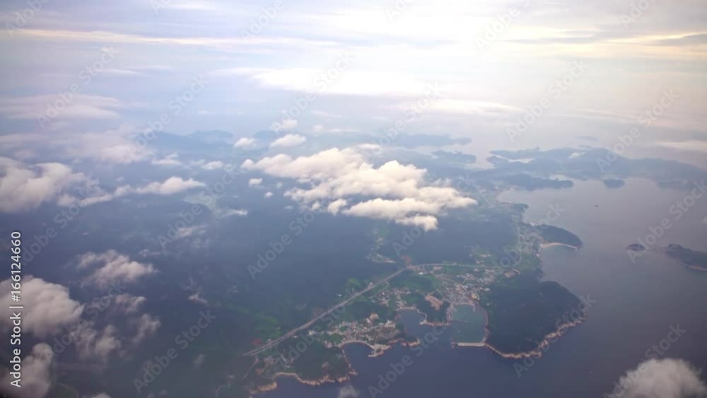 4K Aerial View Of Busan Metropolitan City From Above With Clouds. Traveling by air. Wonderful view of the sky and clouds as seen through an airplane window in South Korea.-Dan 4K Aerial View Of Busan Metropolitan City From Above With Clouds. Traveling by air. Wonderful view of the sky and clouds as seen through an airplane window in South Korea.-Dan