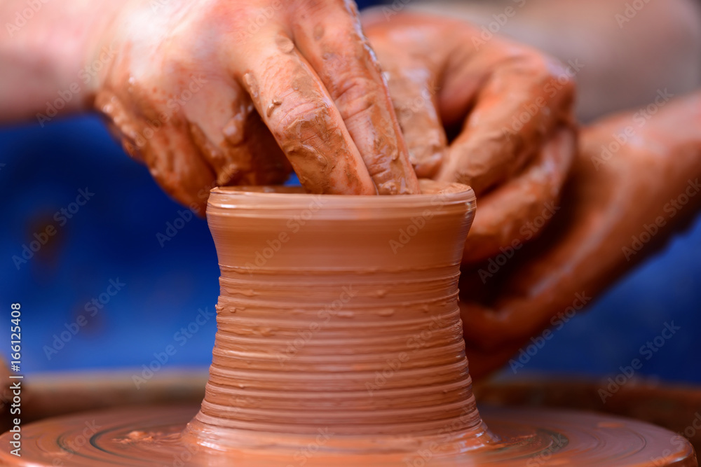 Potter making ceramic pot on the pottery wheel Potter making ceramic pot on the pottery wheel