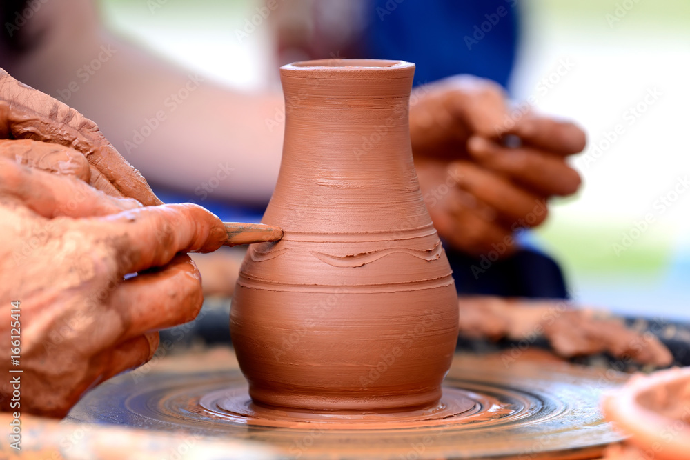 Potter making ceramic pot on the pottery wheel Potter making ceramic pot on the pottery wheel