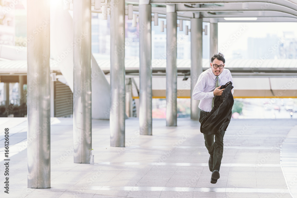 Stressed anxious businessman in a hurry and running, he is late for his business appointment and Wear a shirt while running. Stressed anxious businessman in a hurry and running, he is late for his business appointment and Wear a shirt while running.