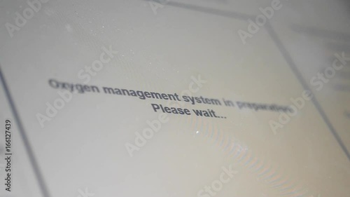Words on the monitor of a laser sintering machine for metal Oxygen management system in preparetion. Please waite... photo