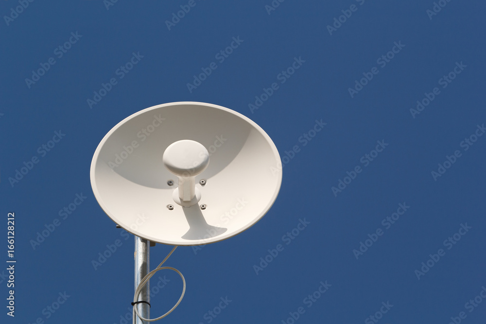Wireless dish antenna and blue sky with copy space Wireless dish antenna and blue sky with copy space