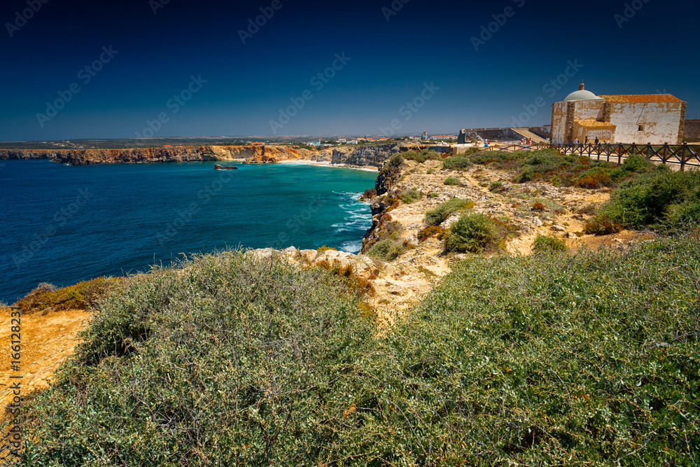 Wide angle shot of the pristine turquoise waters of Sagres Cape in Algarve, Portugal