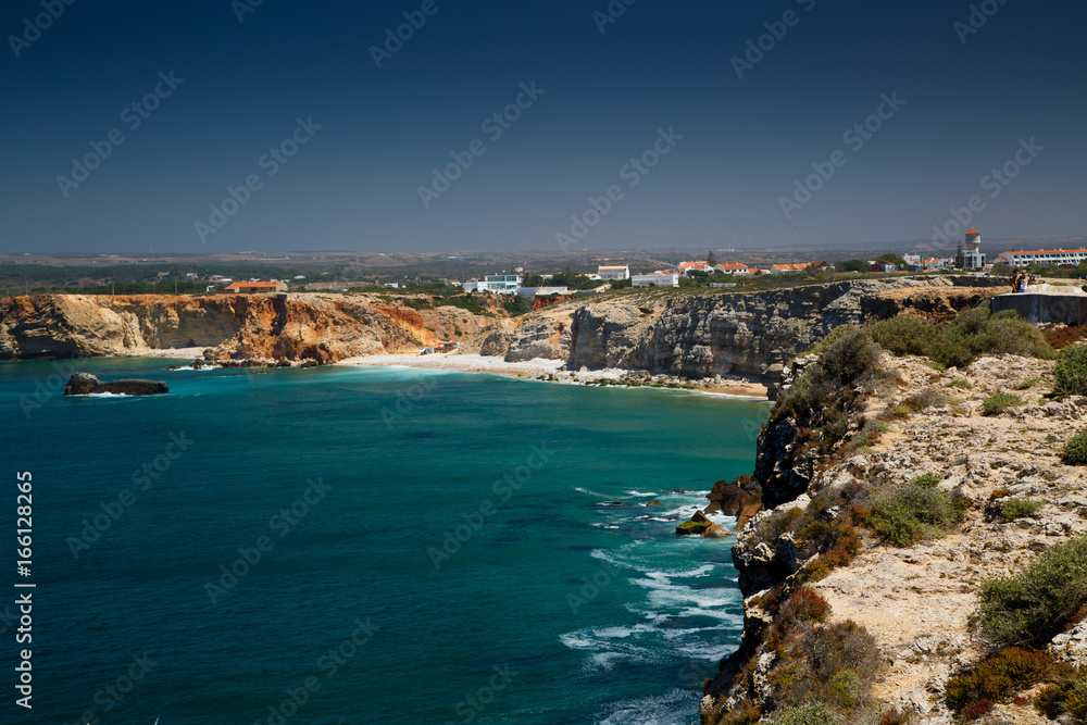 Wide angle shot of the pristine turquoise waters of Sagres Cape and town in Algarve, Portugal